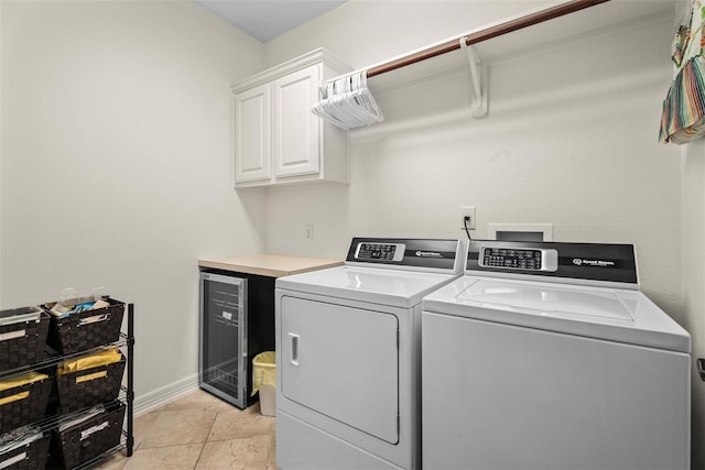 2428 Village Grn, Conroe, TX 77304 - laundry room featuring cabinet space, beverage cooler, washing machine and clothes dryer, and baseboards