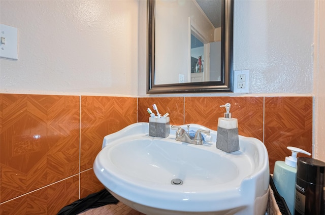 7512 Amarillo St, Houston, TX 77020 - bathroom featuring a sink, wainscoting, and tile walls