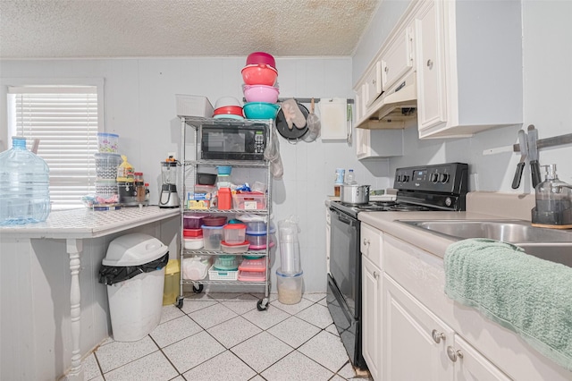 7512 Amarillo St, Houston, TX 77020 - kitchen featuring black appliances, custom range hood, white cabinets, light countertops, and a textured ceiling