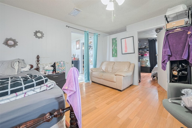 7512 Amarillo St, Houston, TX 77020 - bedroom with light wood-style flooring and a textured ceiling