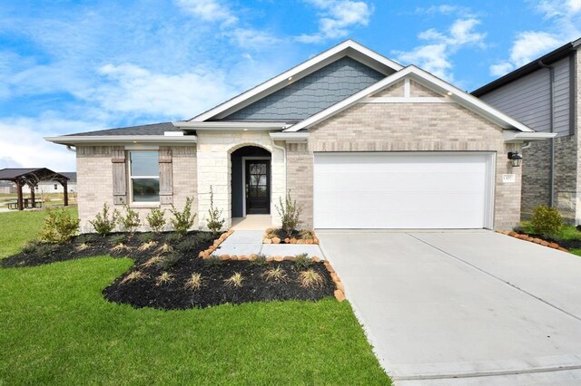 1307 Bonnerjee Dr, Crosby, TX 77532 - view of front of property featuring a garage, concrete driveway, a front lawn, and brick siding