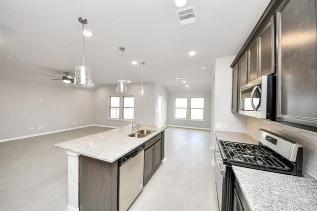 1307 Bonnerjee Dr, Crosby, TX 77532 - kitchen with appliances with stainless steel finishes, open floor plan, a sink, light tile patterned floors, and a ceiling fan