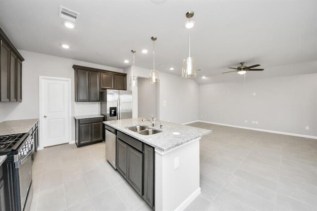 1307 Bonnerjee Dr, Crosby, TX 77532 - kitchen with a sink, stainless steel appliances, a ceiling fan, a center island with sink, and dark brown cabinets