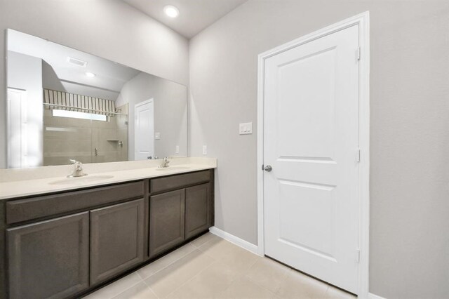 1307 Bonnerjee Dr, Crosby, TX 77532 - full bath with a shower stall, double vanity, baseboards, and tile patterned floors