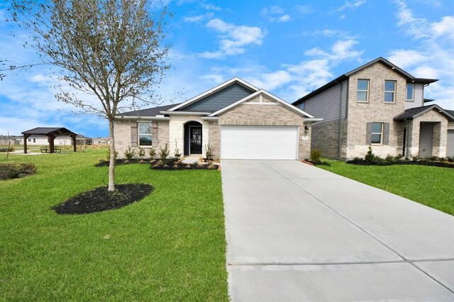 1307 Bonnerjee Dr, Crosby, TX 77532 - view of front of property with concrete driveway, a garage, a front yard, and brick siding