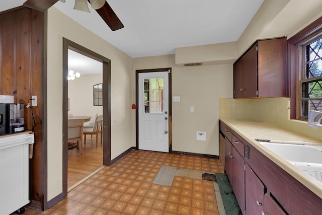 2009 Lamar Dr, Pasadena, TX 77502 - kitchen with tile countertops, a ceiling fan, baseboards, light floors, and tasteful backsplash