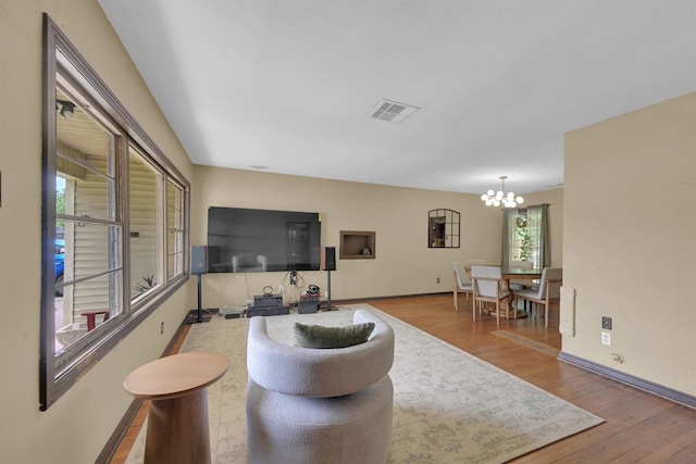 2009 Lamar Dr, Pasadena, TX 77502 - living area featuring a chandelier, wood finished floors, and baseboards