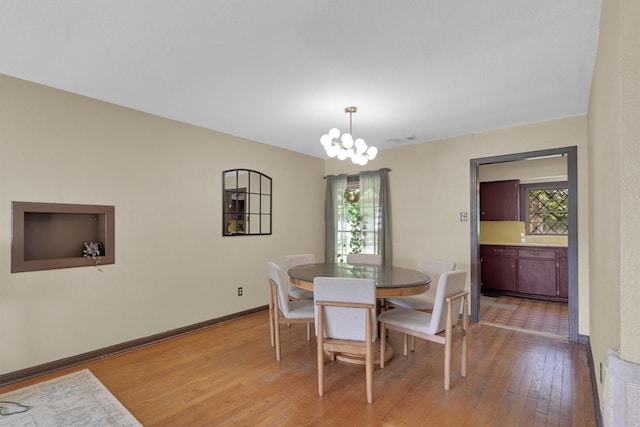 2009 Lamar Dr, Pasadena, TX 77502 - dining space with light wood finished floors, a chandelier, and baseboards