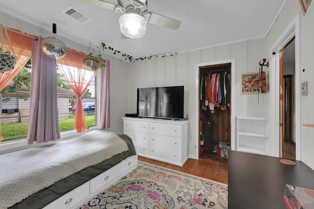 2009 Lamar Dr, Pasadena, TX 77502 - bedroom featuring wood finished floors, a spacious closet, a closet, and a ceiling fan