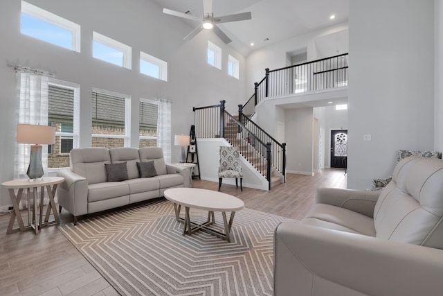 308 Spruce Oak Ln, Waller, TX 77484 - living area featuring a high ceiling, light wood-type flooring, a ceiling fan, stairway, and recessed lighting
