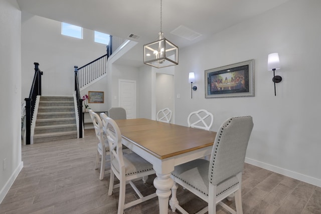 308 Spruce Oak Ln, Waller, TX 77484 - dining area with light wood-style flooring, baseboards, stairway, and a chandelier