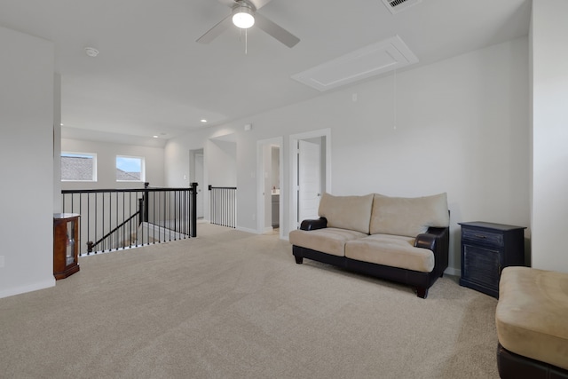 308 Spruce Oak Ln, Waller, TX 77484 - living area with attic access, ceiling fan, carpet flooring, baseboards, and an upstairs landing