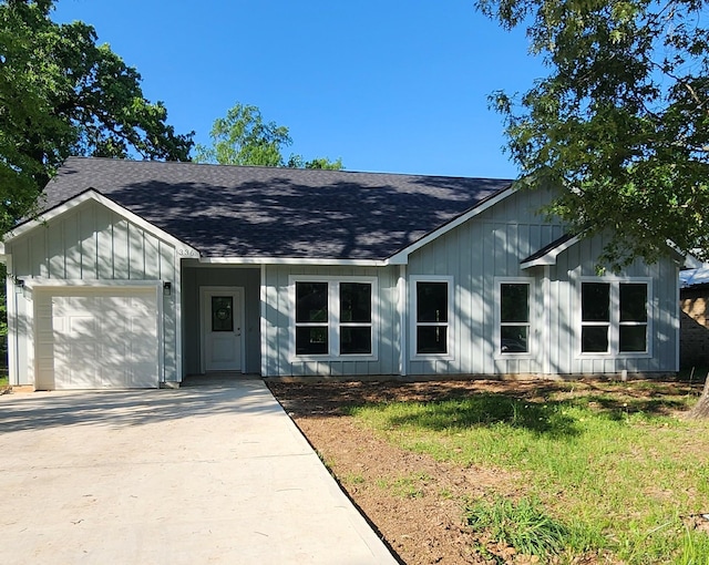 336 Autumn Ln, Livingston, TX 77351 - view of front facade with a shingled roof, board and batten siding, driveway, and a garage