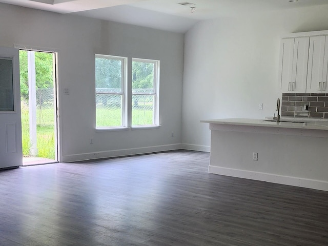 336 Autumn Ln, Livingston, TX 77351 - unfurnished living room with a sink, dark wood-type flooring, and baseboards