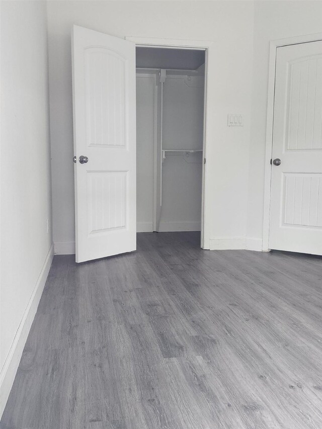 336 Autumn Ln, Livingston, TX 77351 - unfurnished bedroom featuring wood finished floors, baseboards, and a closet