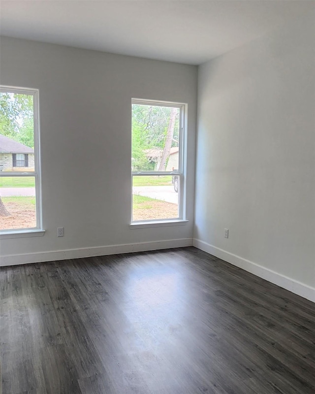 336 Autumn Ln, Livingston, TX 77351 - unfurnished room with healthy amount of natural light, dark wood-style flooring, and baseboards