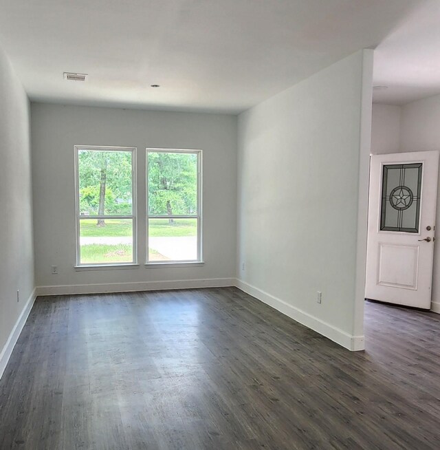 336 Autumn Ln, Livingston, TX 77351 - empty room featuring baseboards and dark wood-style flooring