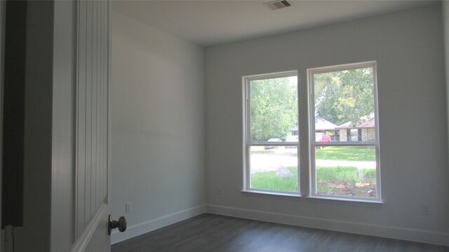 336 Autumn Ln, Livingston, TX 77351 - spare room featuring dark wood-style flooring and baseboards