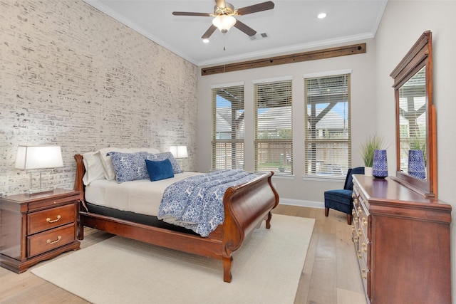 4320 Silver Oak Pl, Spring, TX 77386 - bedroom with light wood-type flooring, crown molding, baseboards, an accent wall, and ceiling fan