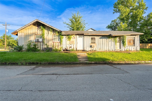 202 Booker T Washington St, Conroe, TX 77301 - ranch-style house with board and batten siding and a front lawn