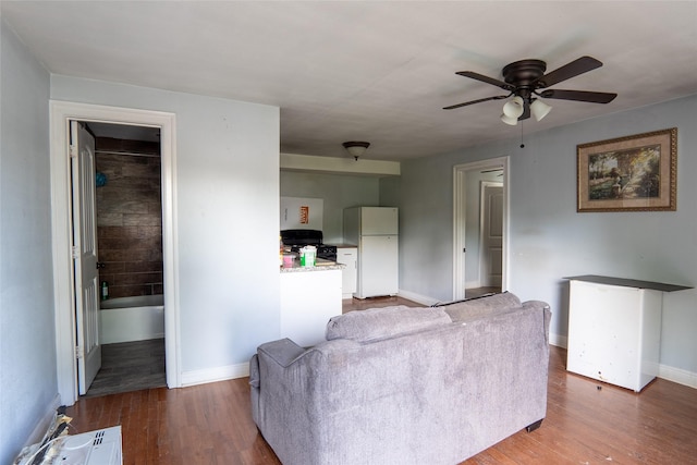 202 Booker T Washington St, Conroe, TX 77301 - living area featuring ceiling fan, baseboards, and wood finished floors
