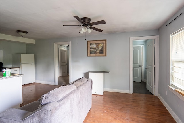 202 Booker T Washington St, Conroe, TX 77301 - living area featuring wood finished floors, ceiling fan, and baseboards
