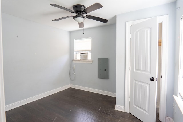 202 Booker T Washington St, Conroe, TX 77301 - unfurnished bedroom with electric panel, dark wood-type flooring, baseboards, cooling unit, and a ceiling fan