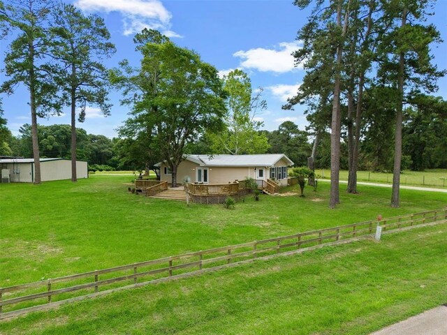 15460 Paradise Point Dr, Willis, TX 77318 - view of yard featuring a deck and view of wooded area