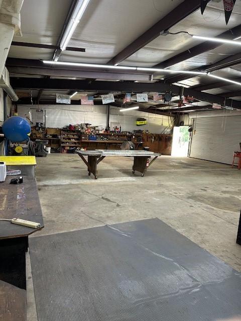 15460 Paradise Point Dr, Willis, TX 77318 - garage featuring a workshop area
