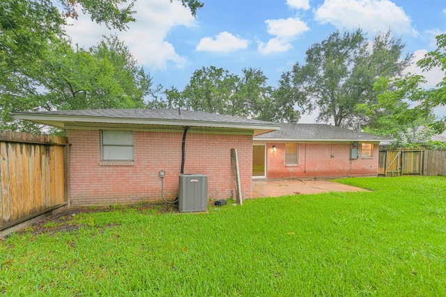 100 Harold Ln, Baytown, TX 77521 - rear view of property featuring central AC, a patio, and brick siding