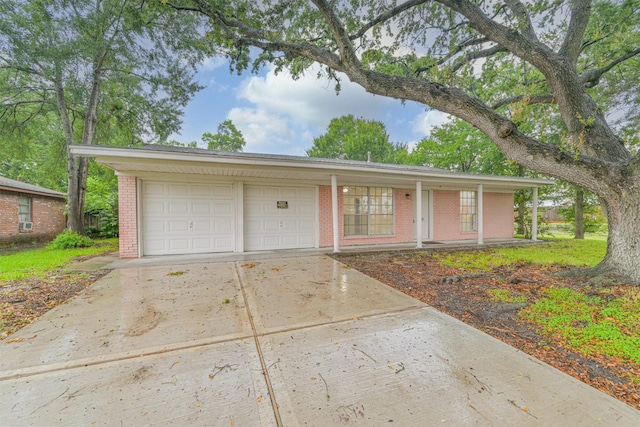 100 Harold Ln, Baytown, TX 77521 - ranch-style home with brick siding, driveway, a porch, and an attached garage