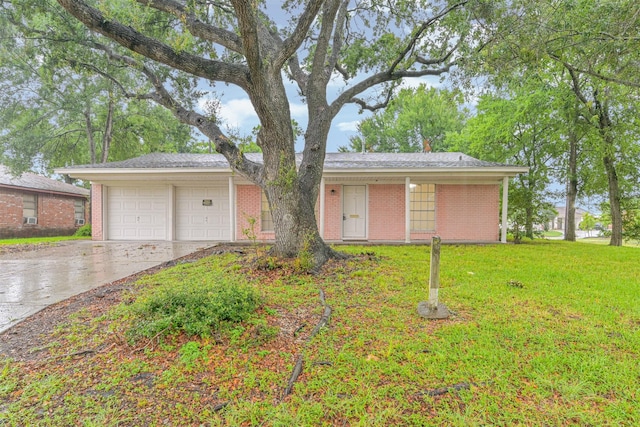 100 Harold Ln, Baytown, TX 77521 - single story home featuring driveway, brick siding, and a front yard