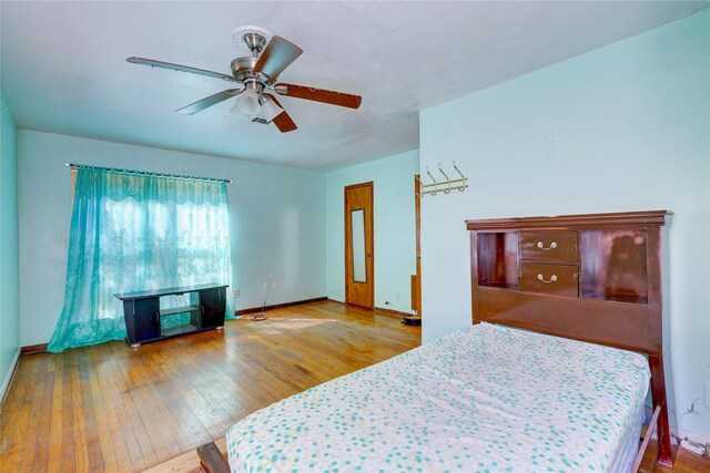 2630 Tidewater Dr, Houston, TX 77045 - bedroom featuring hardwood / wood-style floors, baseboards, and ceiling fan