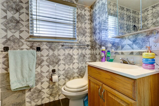 2630 Tidewater Dr, Houston, TX 77045 - bathroom with vanity, tile walls, and toilet