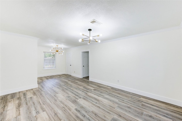 5326 Keystone St, Houston, TX 77021 - empty room with a chandelier, crown molding, light wood-style floors, baseboards, and a textured ceiling