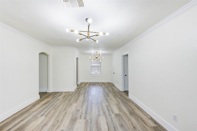 5326 Keystone St, Houston, TX 77021 - spare room featuring a chandelier, arched walkways, crown molding, light wood-style floors, and baseboards