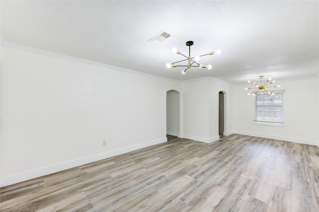 5326 Keystone St, Houston, TX 77021 - empty room with a chandelier, arched walkways, light wood finished floors, crown molding, and baseboards
