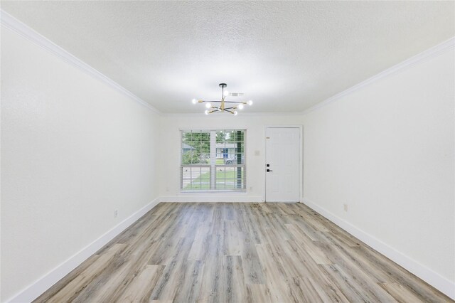 5326 Keystone St, Houston, TX 77021 - unfurnished room featuring a chandelier, ornamental molding, light wood-style floors, baseboards, and a textured ceiling