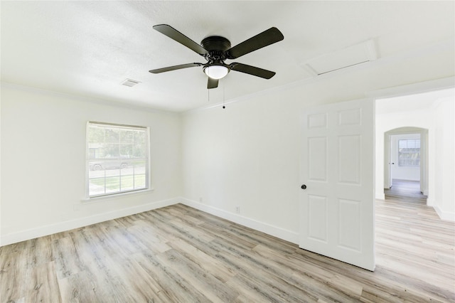 5326 Keystone St, Houston, TX 77021 - empty room featuring light wood finished floors, healthy amount of natural light, attic access, baseboards, and ornamental molding