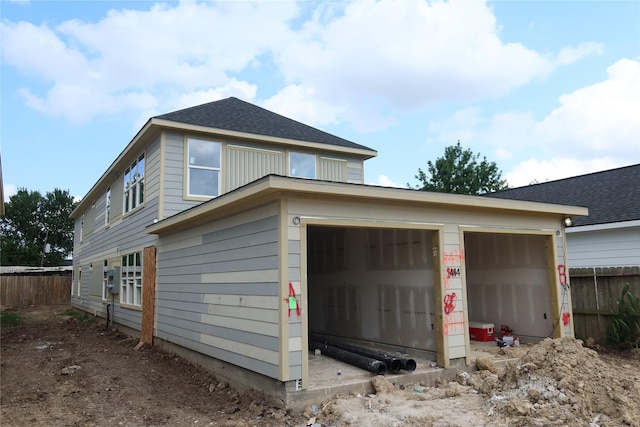 4702 Baton Rouge St, Houston, TX 77028 - view of side of property featuring a garage and roof with shingles