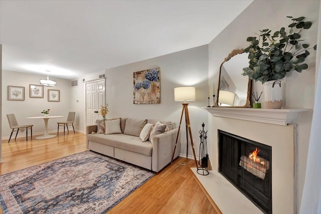 2120 El Paseo St Unit 2409, Houston, TX 77054 - living room with wood finished floors, a fireplace with flush hearth, and baseboards