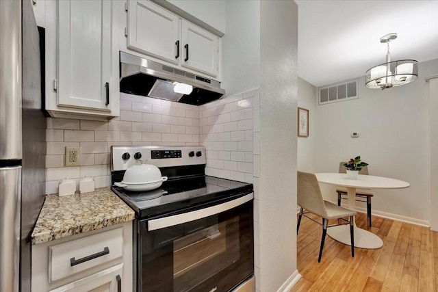 2120 El Paseo St Unit 2409, Houston, TX 77054 - kitchen with appliances with stainless steel finishes, under cabinet range hood, tasteful backsplash, light wood-type flooring, and light stone countertops