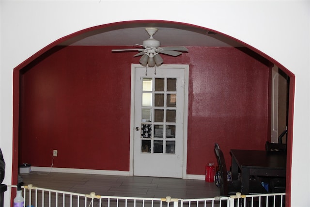 7615 Appleton St, Houston, TX 77022 - additional living space with arched walkways, wood finished floors, and a ceiling fan