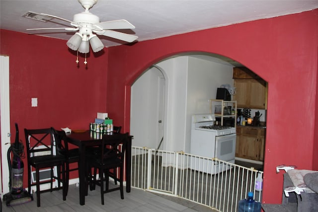 7615 Appleton St, Houston, TX 77022 - dining space with ceiling fan, arched walkways, and wood finished floors