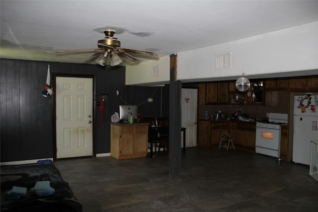7615 Appleton St, Houston, TX 77022 - garage with freestanding refrigerator, a ceiling fan, and wood walls