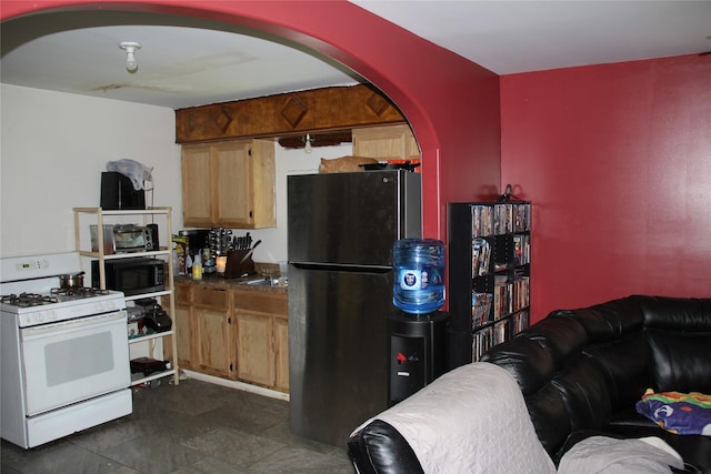 7615 Appleton St, Houston, TX 77022 - kitchen featuring black appliances, arched walkways, and dark countertops
