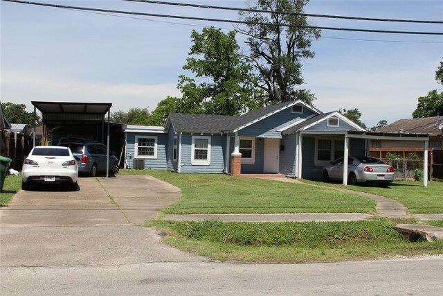 7615 Appleton St, Houston, TX 77022 - view of front of property featuring a carport, concrete driveway, and a front lawn