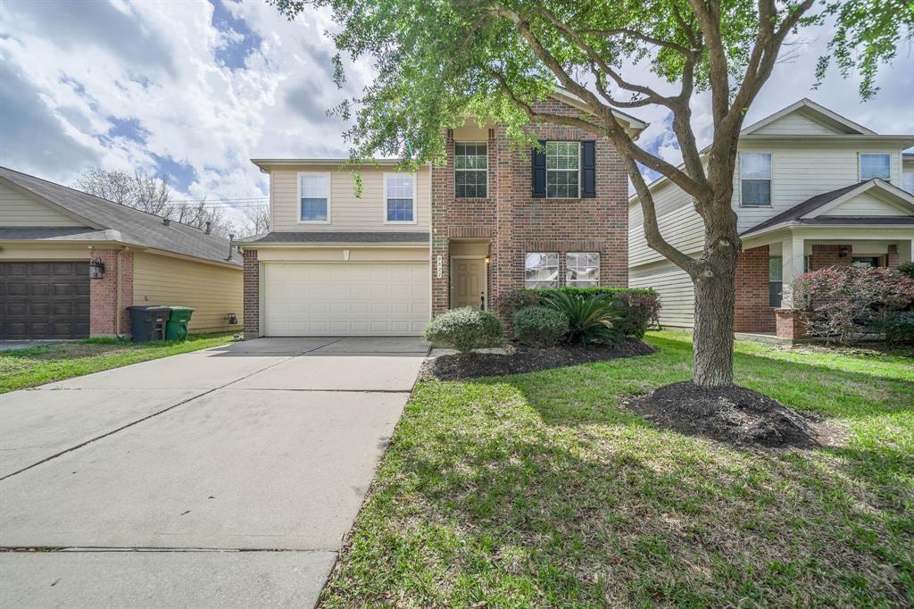 9322 Canady Park Ln, Houston, TX 77075 - traditional home with brick siding, an attached garage, concrete driveway, and a front lawn
