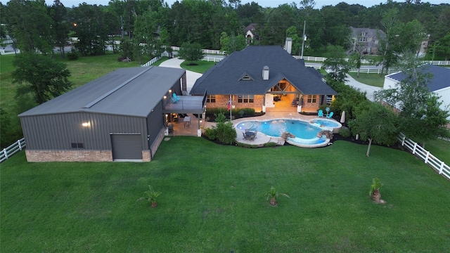 32710 Tall Oaks Way, Magnolia, TX 77354 - back of house with an outbuilding, a pool with connected hot tub, and a garage
