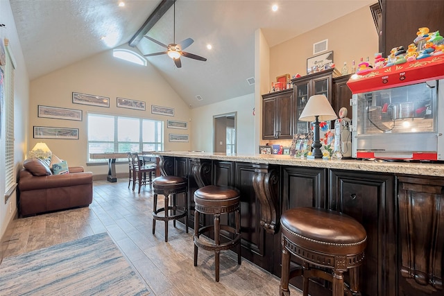 32710 Tall Oaks Way, Magnolia, TX 77354 - bar with ceiling fan, light wood-style flooring, baseboards, beam ceiling, and high vaulted ceiling